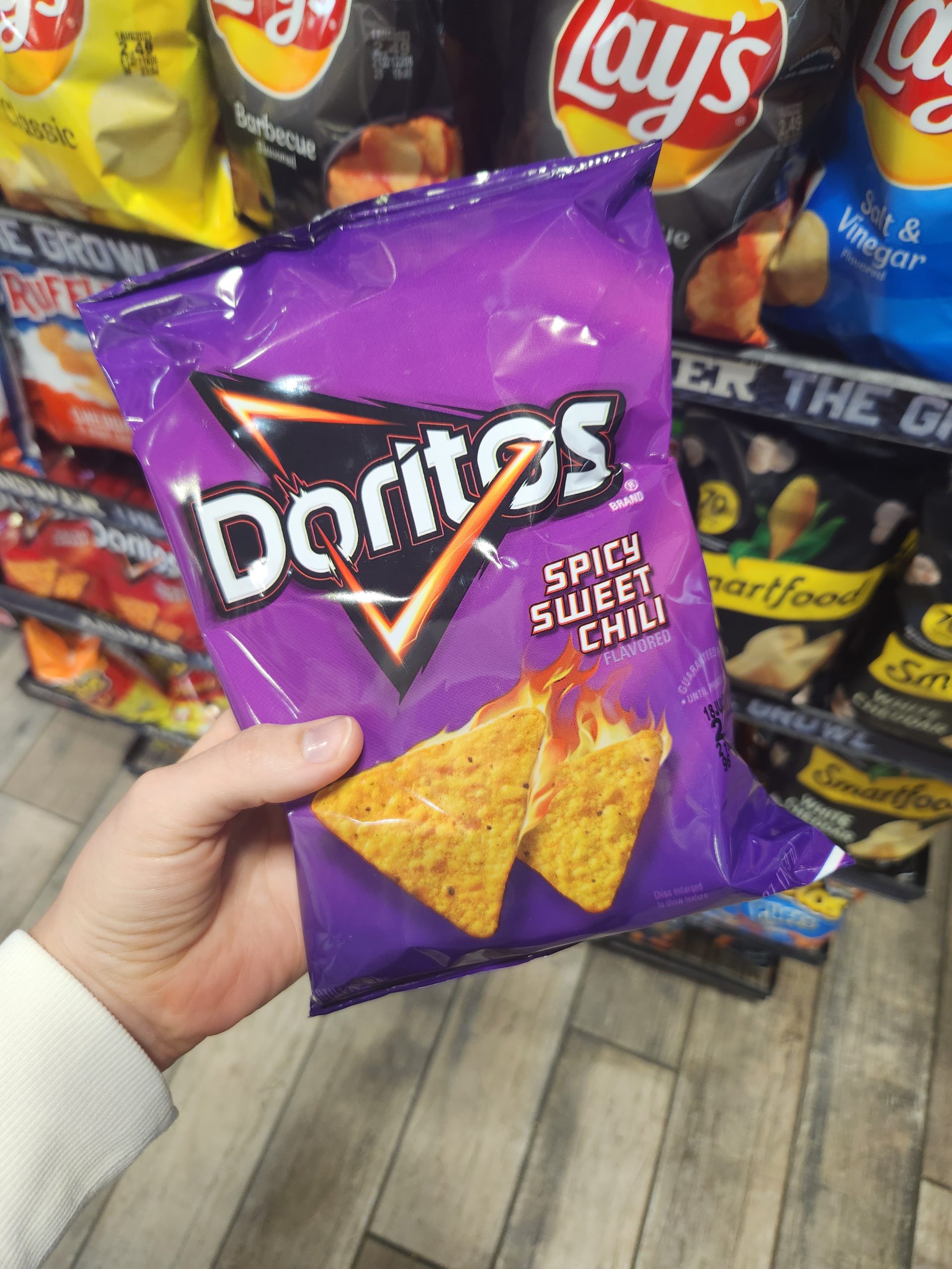 Person holding Doritos in-store