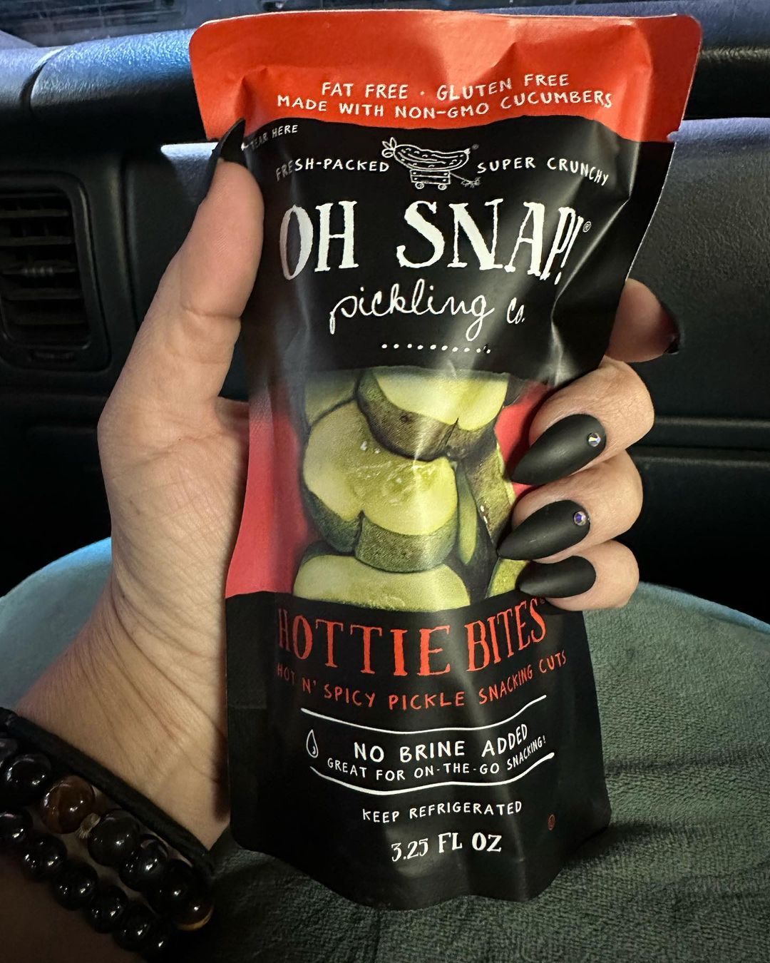 Person holding Oh Snap! pickles pack