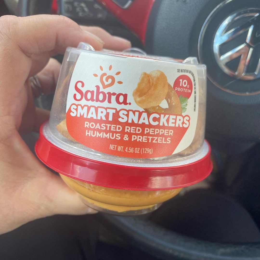 Person holding Sabra Smart Snackers pack