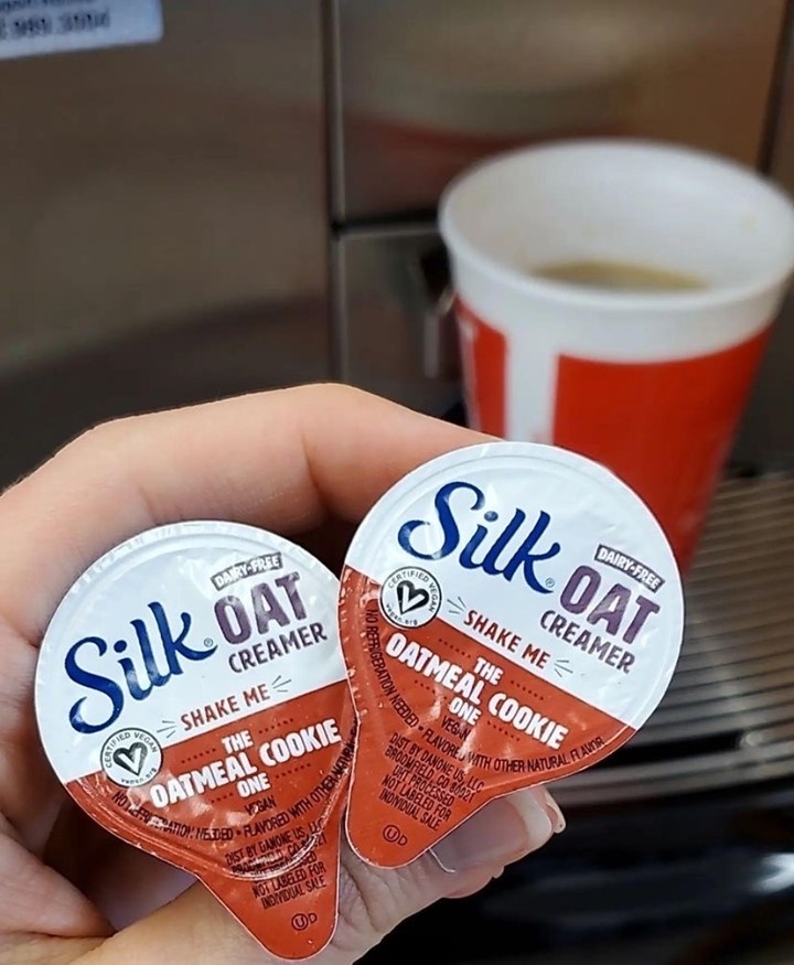Person holding Silk Oat Milk creamer