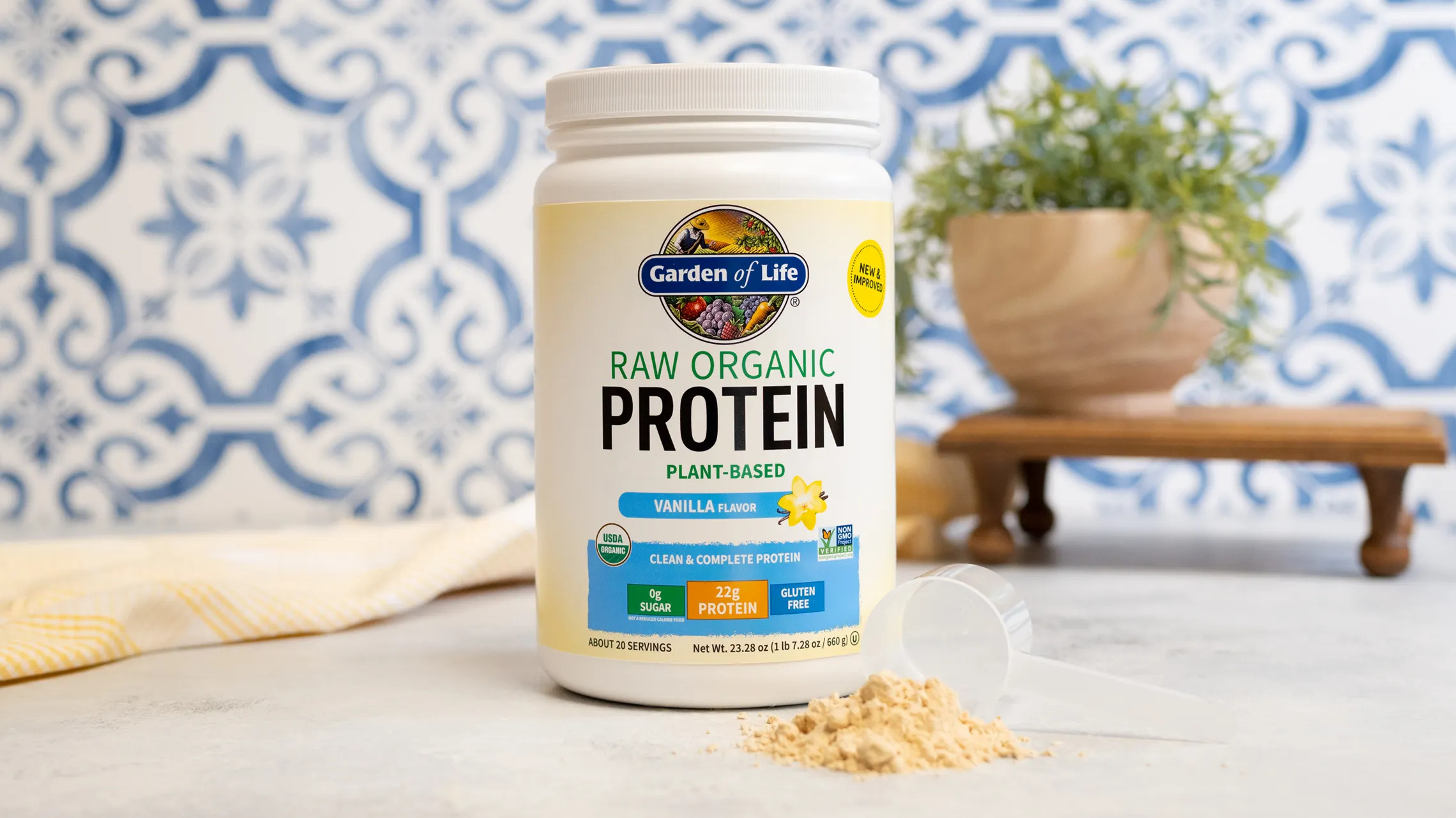 Garden of Life protein on counter with plant in the background