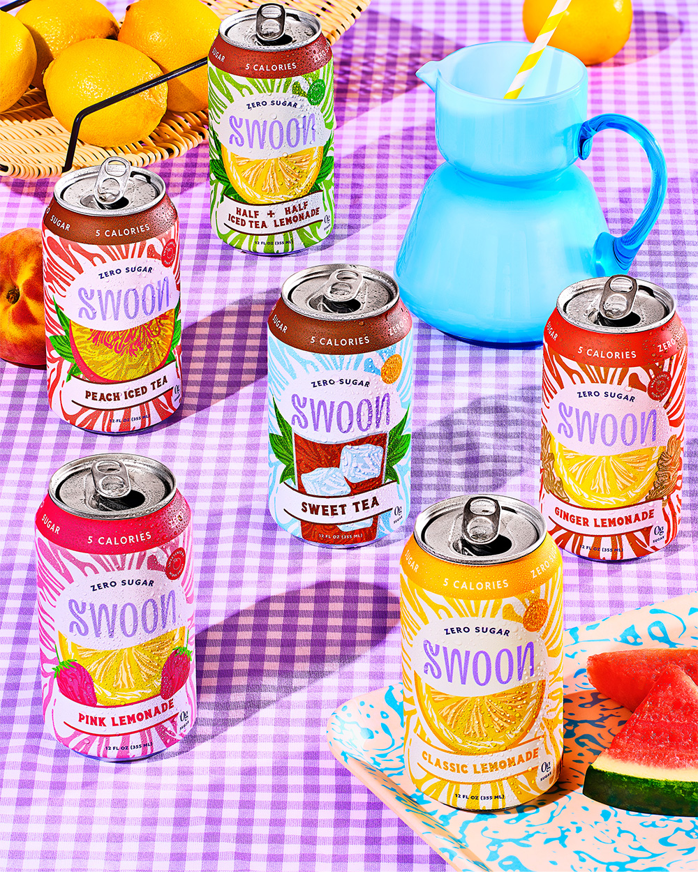 Swoon cans with pitcher on picnic blanket