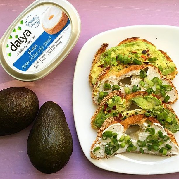 Daiya vegan cream cheese container with avocado and toast on plate