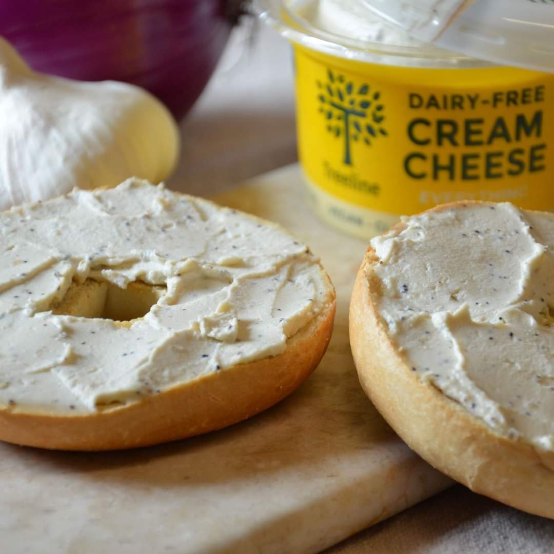 Treeline vegan cream cheese with bagel on cutting board