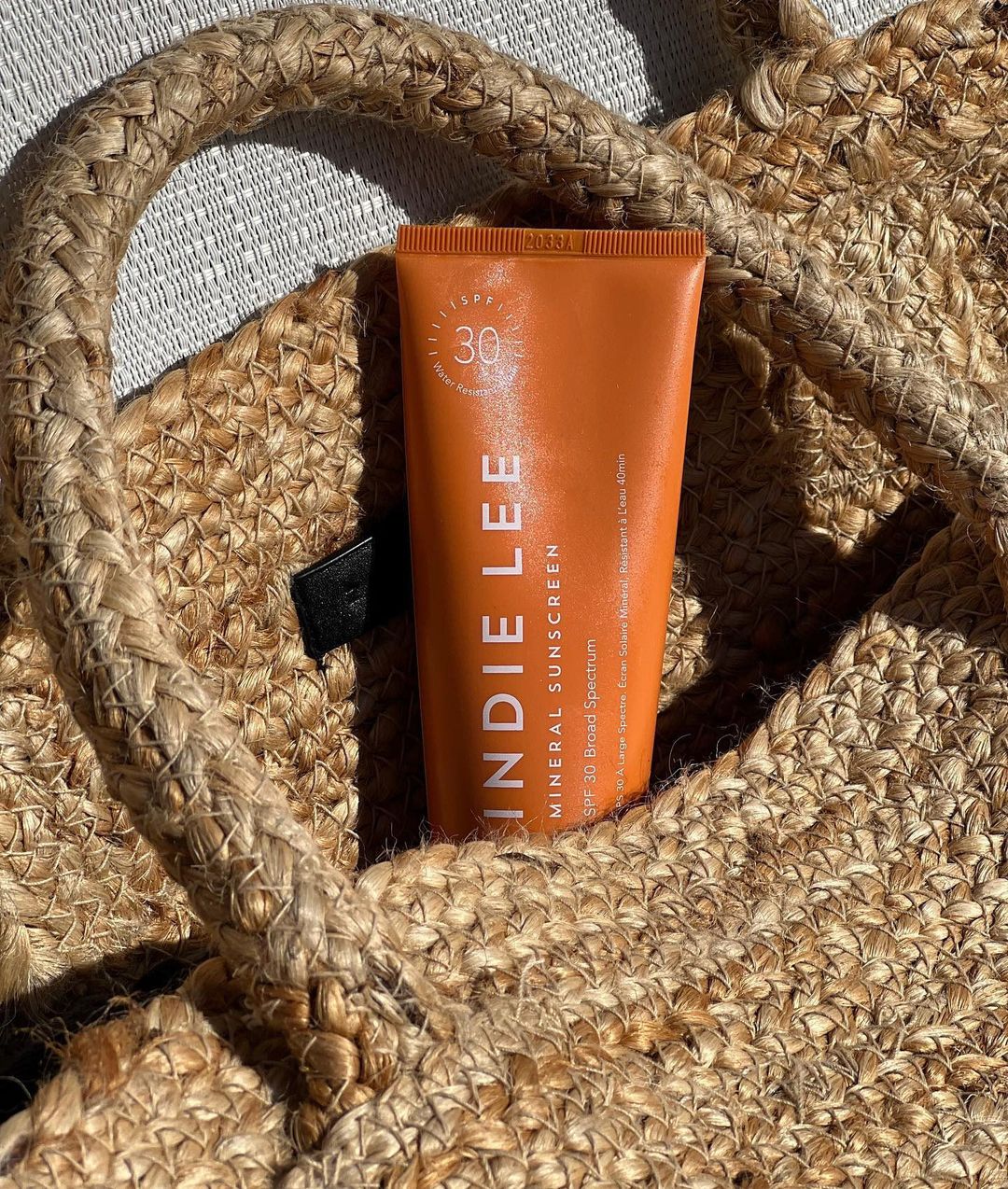Indie Lee sunscreen in purse