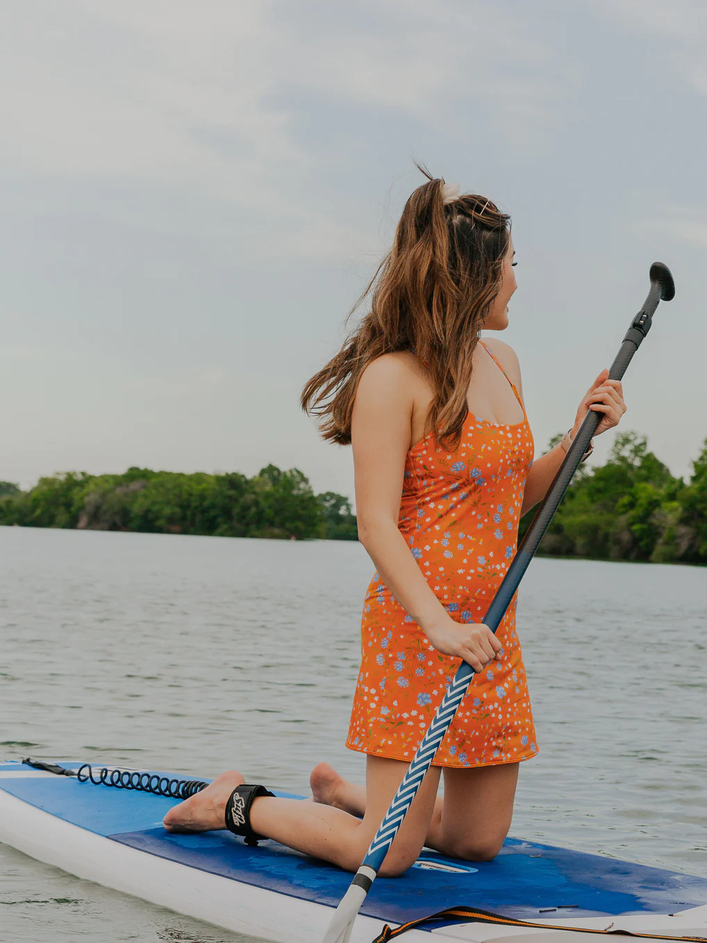 Person on paddle board wearing Kitty and Vibe