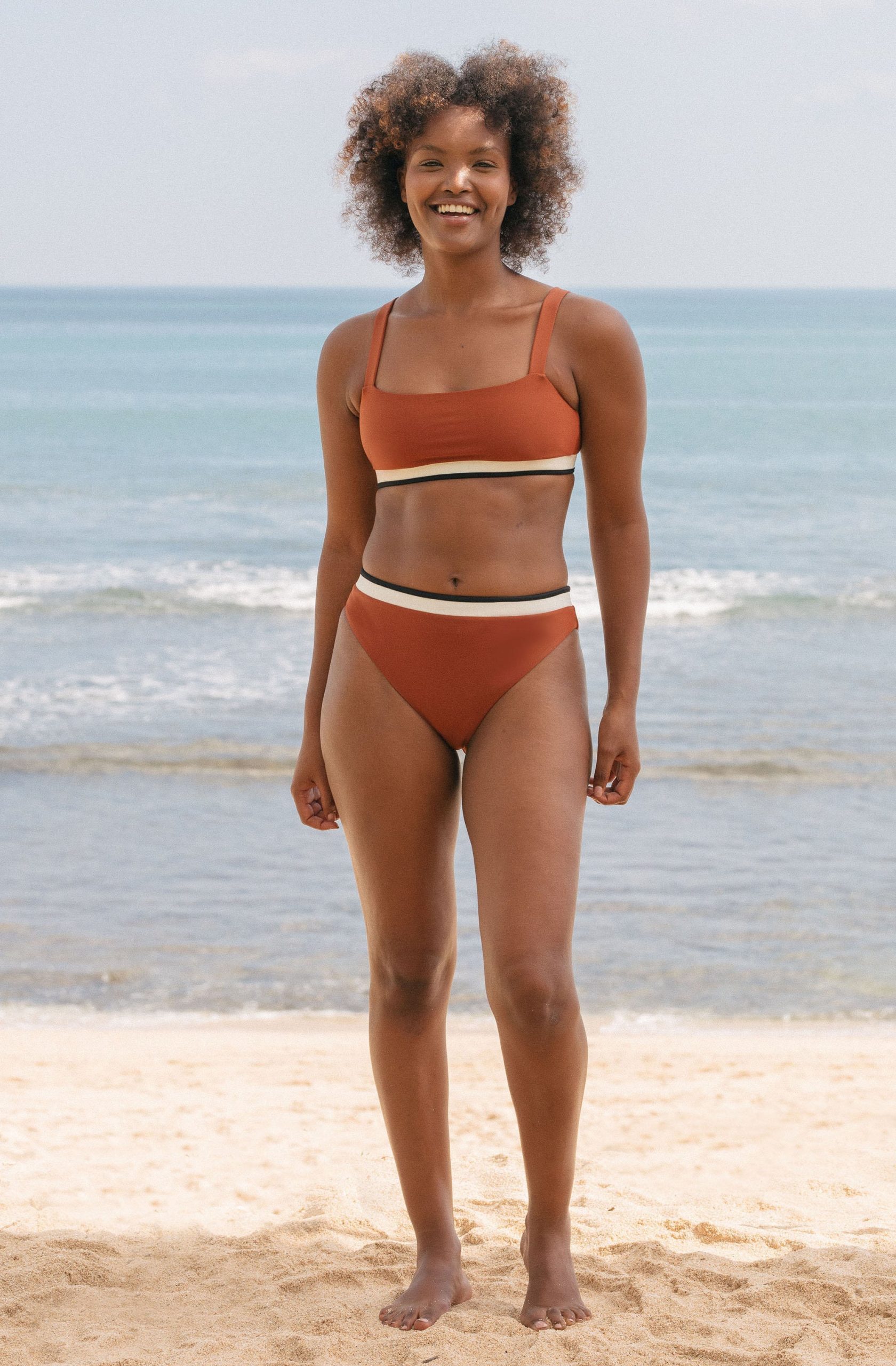 Person wearing SEPTEMBER swimwear on the beach