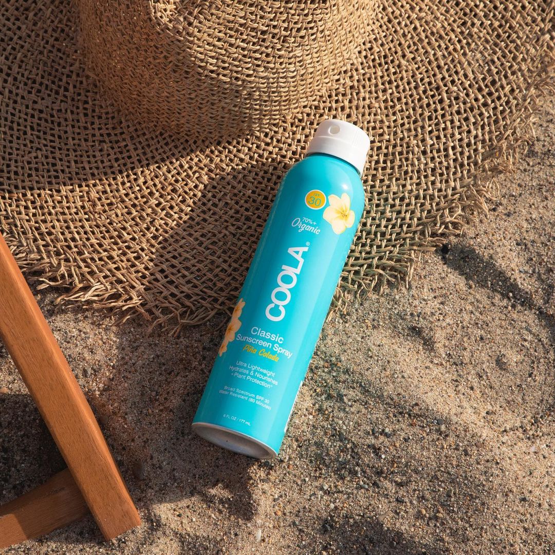 Coola sunscreen on sand