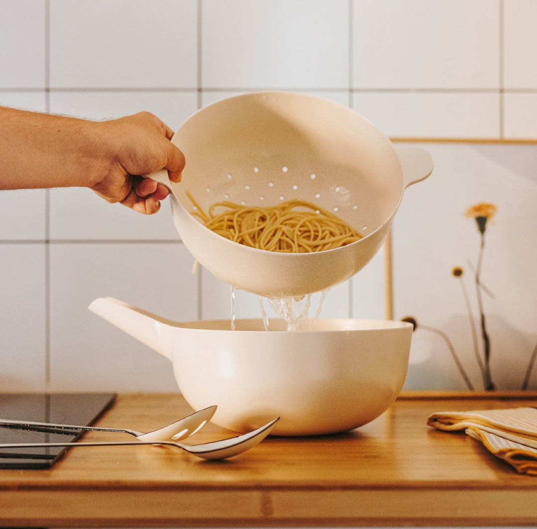EKOBO strainer and pot straining pasta on counter