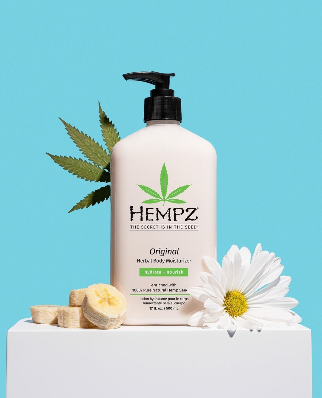 Hempz lotion on stand with flowers and bananas