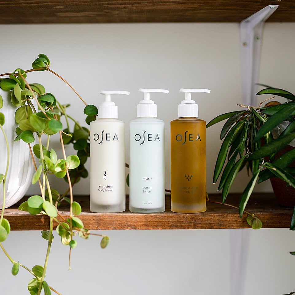 OSEA lotions and oil on shelf with plants