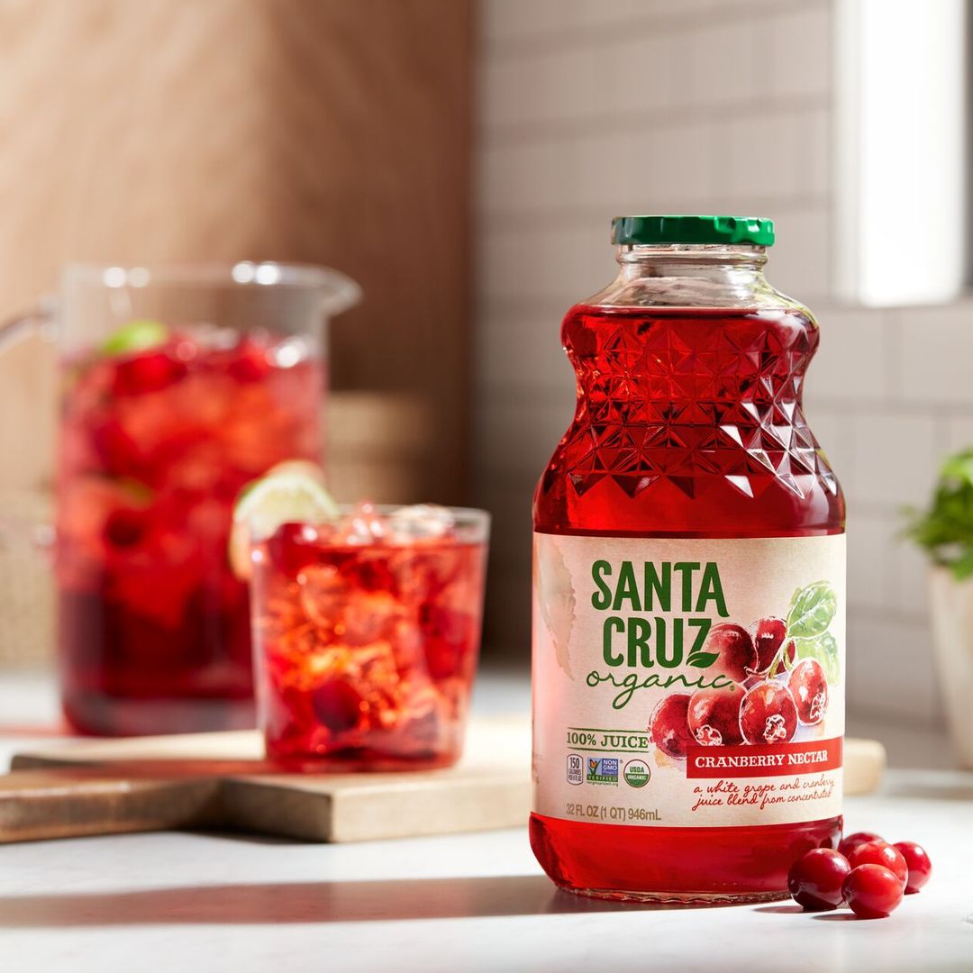Santa Cruz Organic juice on kitchen counter with fresh berries