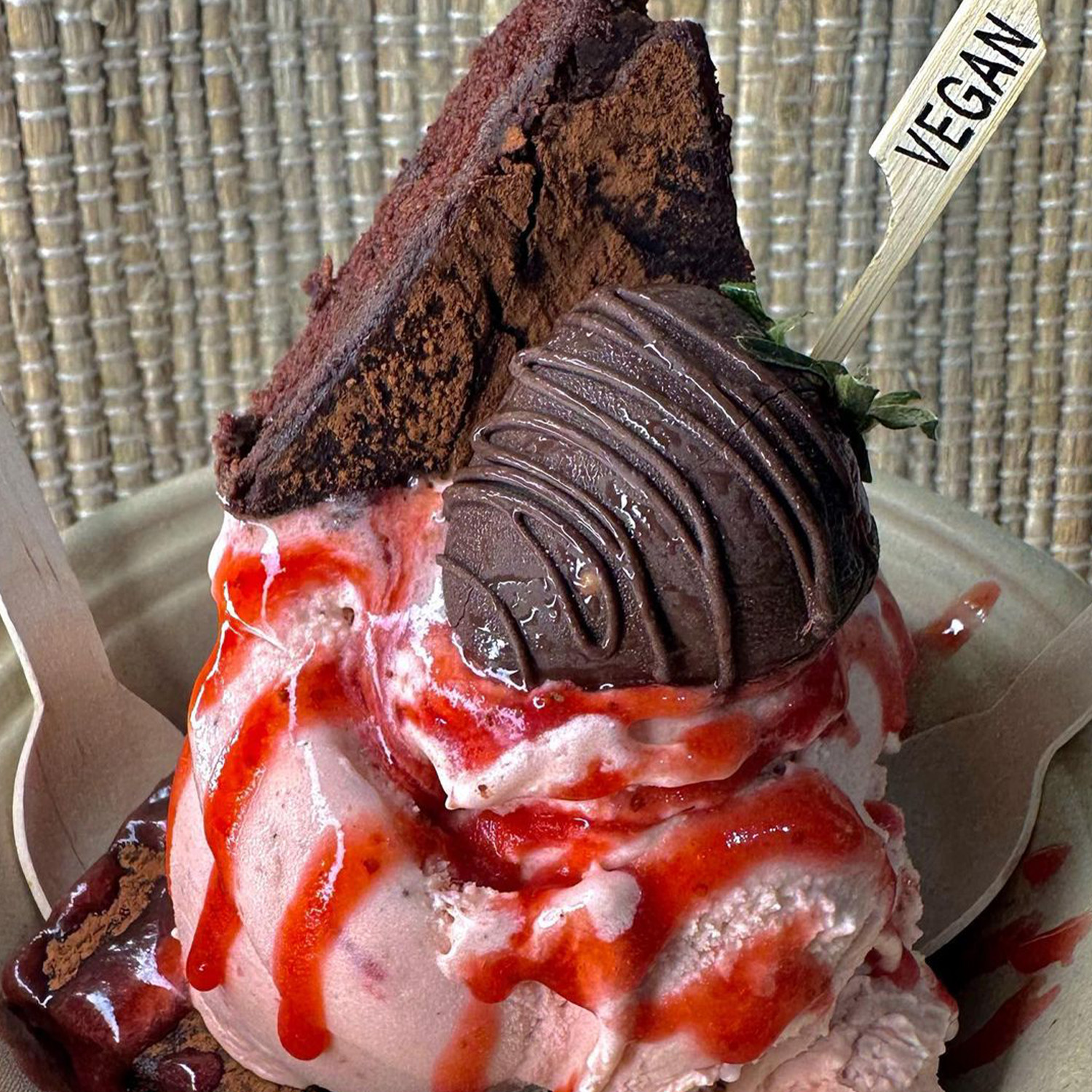 Vegan strawberry ice cream with chocolate covered strawberry and brownie