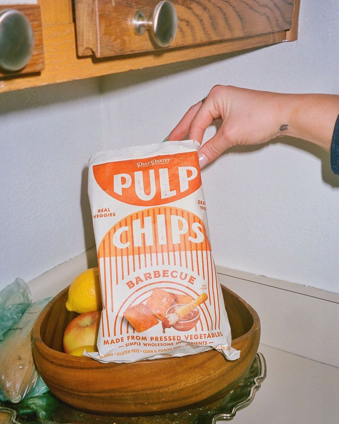 Person grabbing Pulp Pantry Chips
