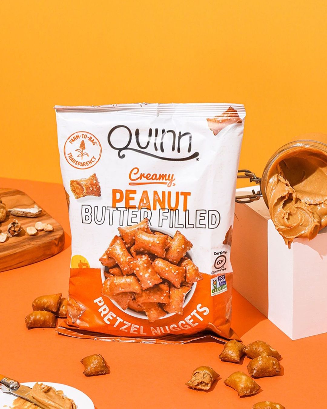 Quinn Snacks peanut butter pretzels scattered with bag