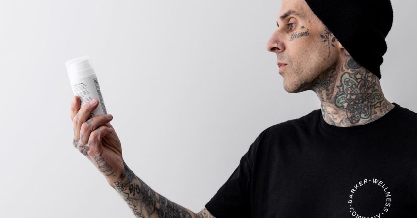 Travis Barker looking at Barker Wellness product