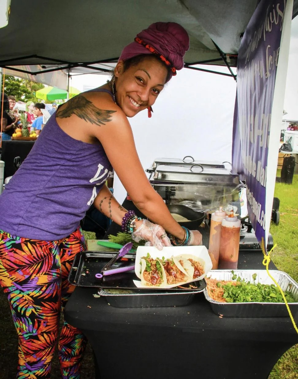 Person serving vegan food at festival