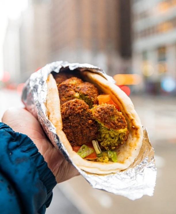 Person holding wrap from The Halal Guys