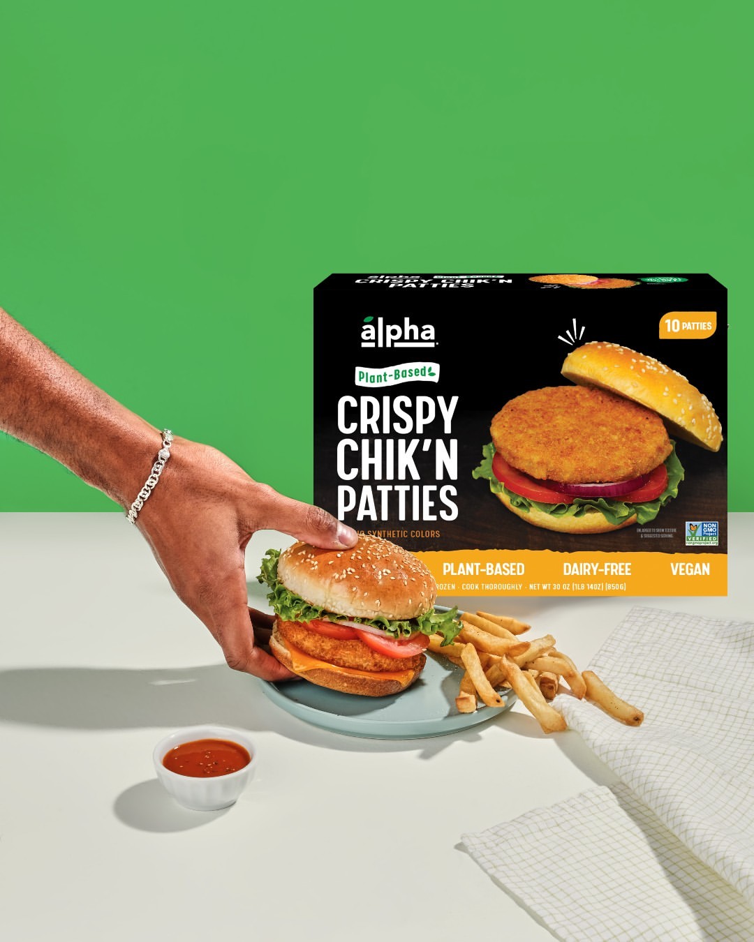 Alpha packaging with person holding chick'n sandwich