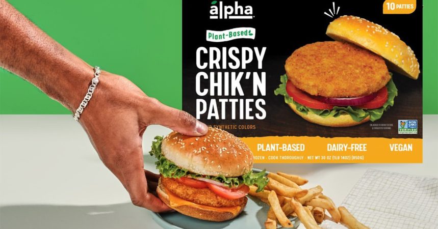 Person holding Alpha sandwich with packaging in the background