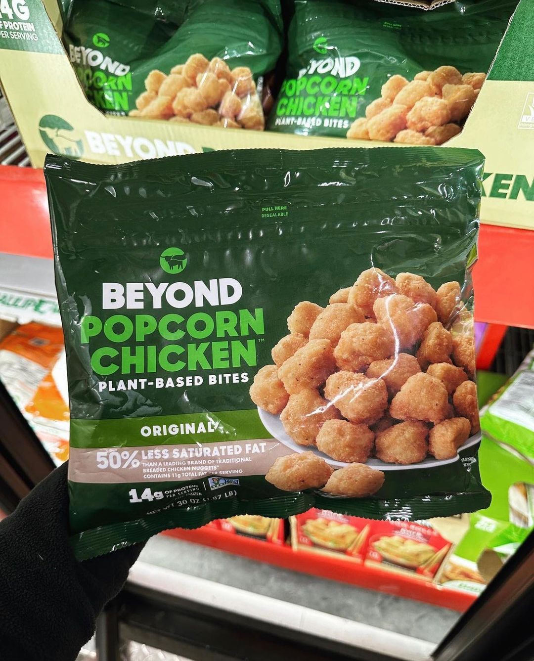 Kreg Sterns holding Beyond Popcorn Chicken in grocery store