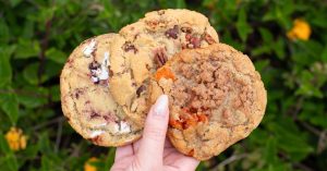 Person holding cookies from Maya's Cookies