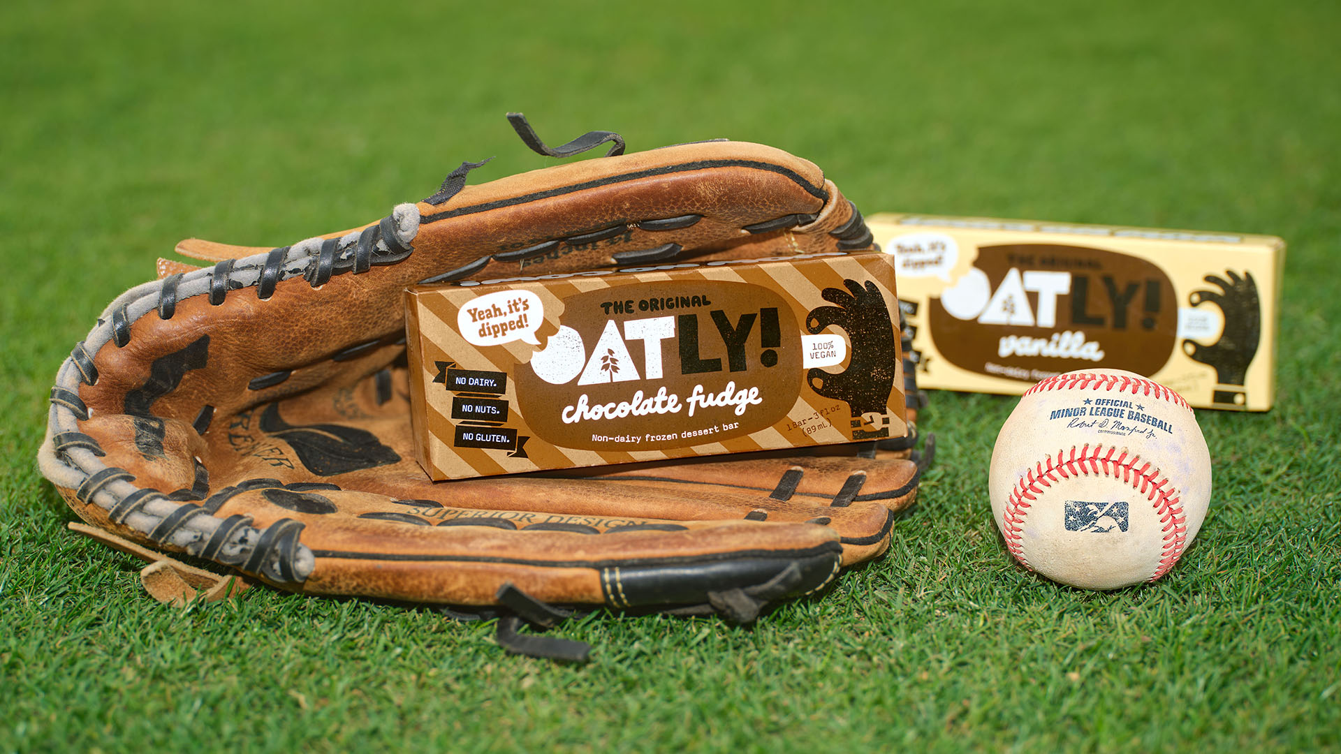 Glove, ball, and Oatly on baseball field