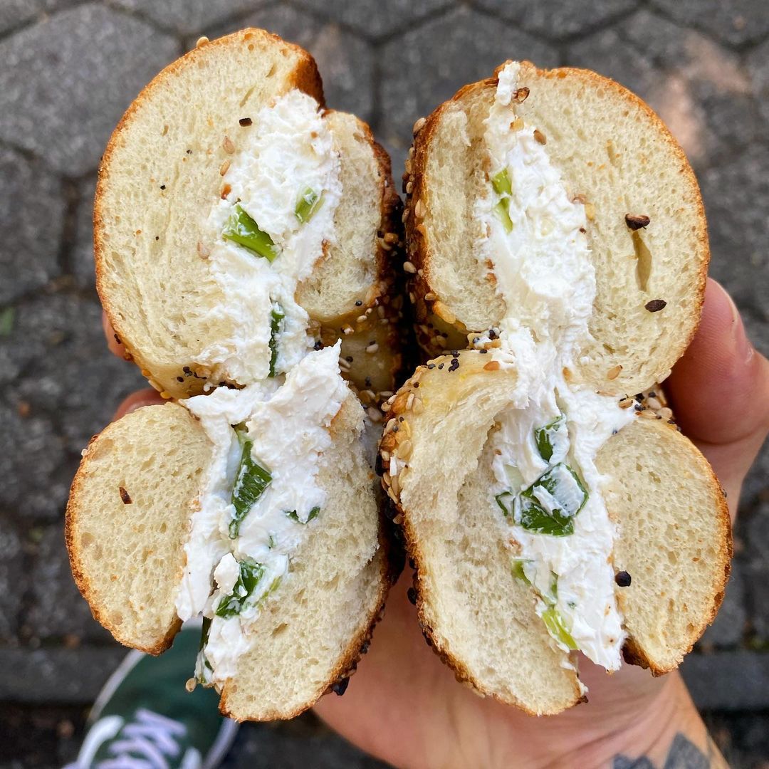 Person holding bagel sandwich from Tompkins Square Bagels