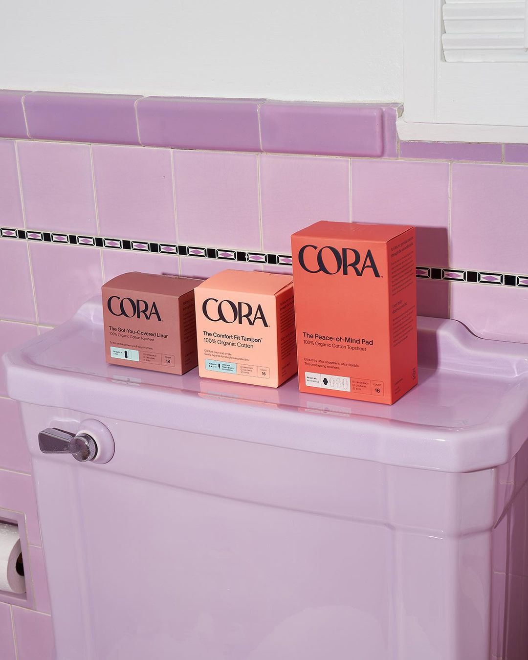 Cora packaging sitting on the back of the toilet