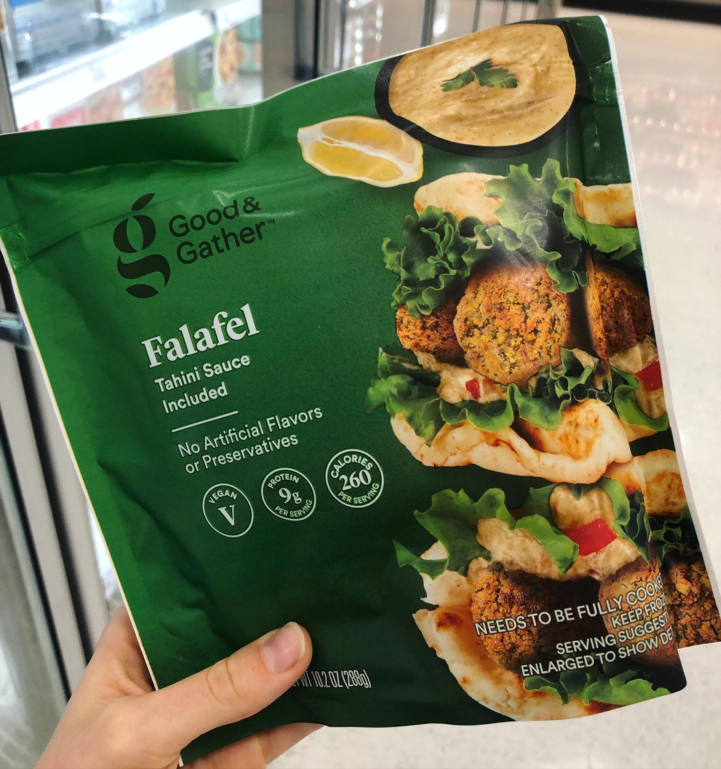 Person holding vegan falafel in store