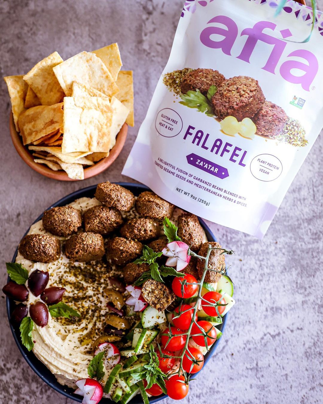 Bag of falafel from Afia Foods with food on table