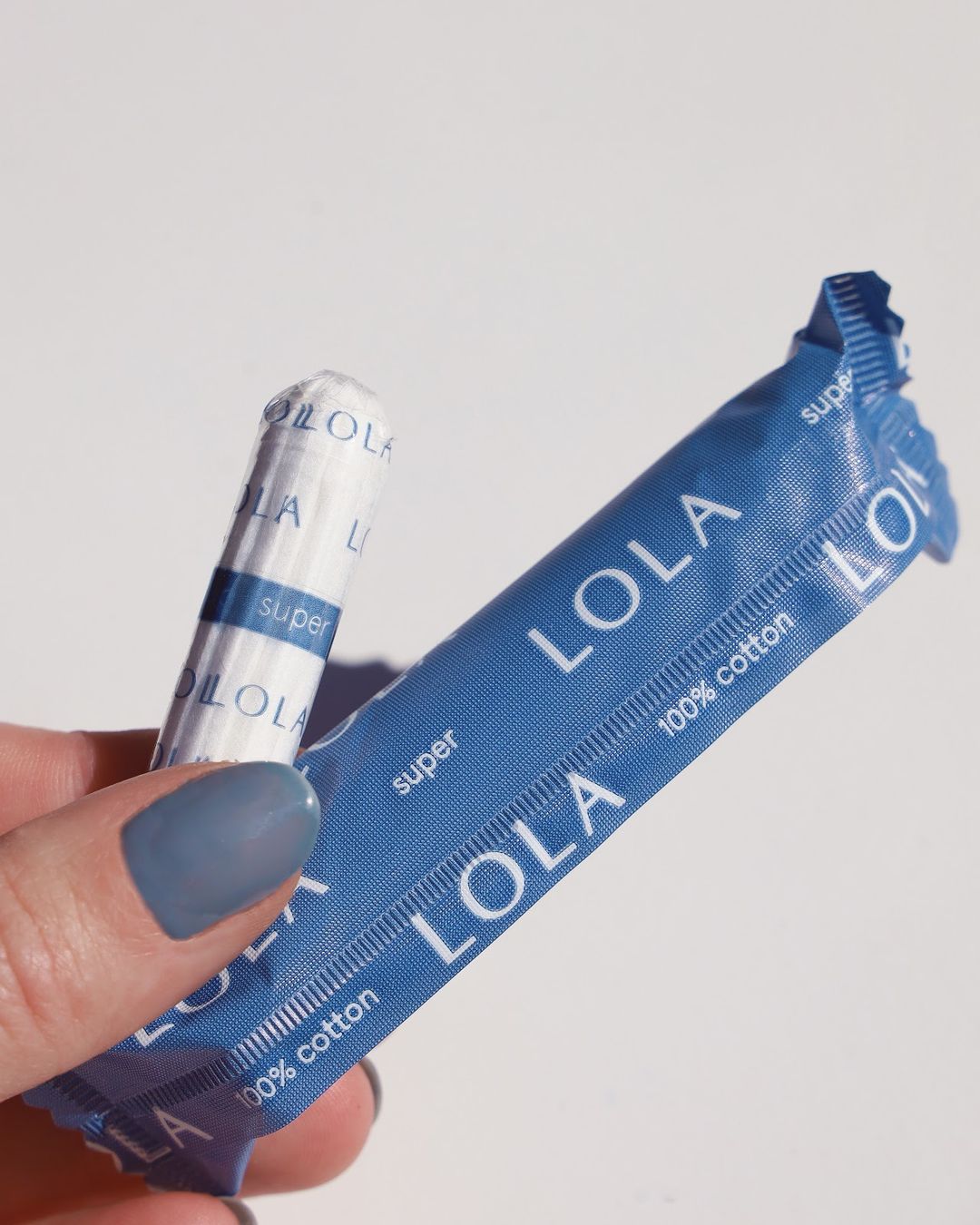 Person holding tampon from Lola