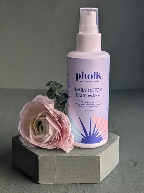 Polk Beauty product with flower on shelf