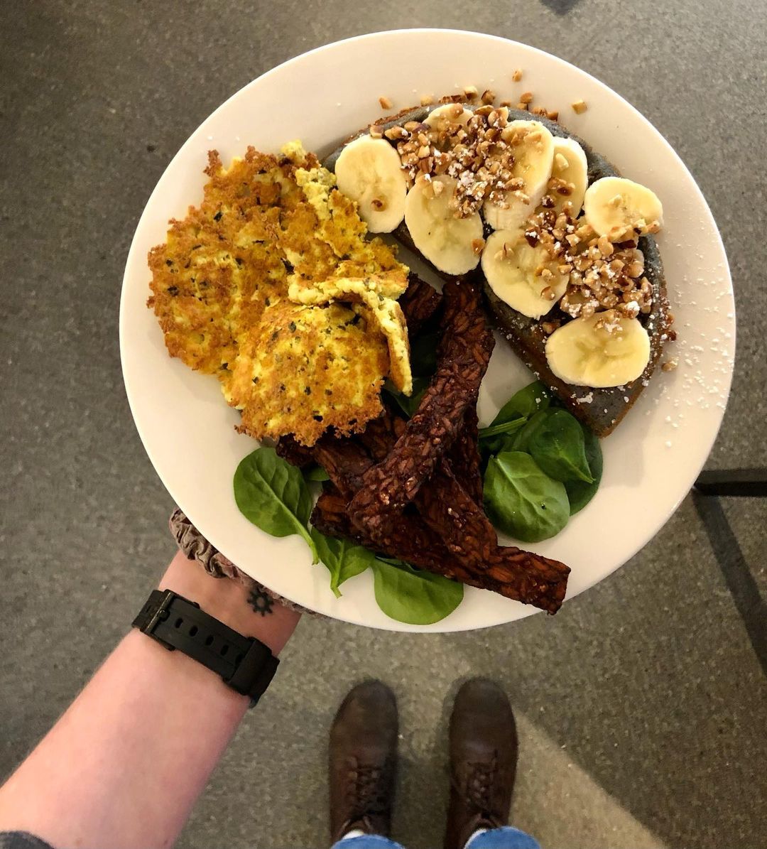 Person holding vegan plate of food from Off The Griddle