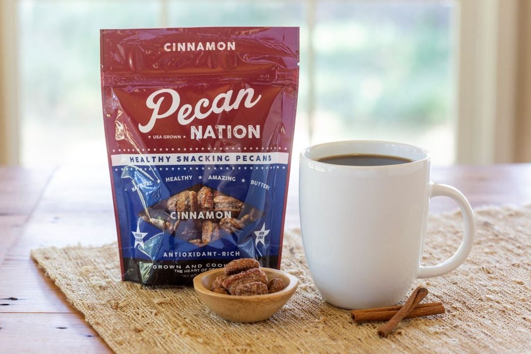 Pecan Nation vegan pecans with coffee and cinnamon on table