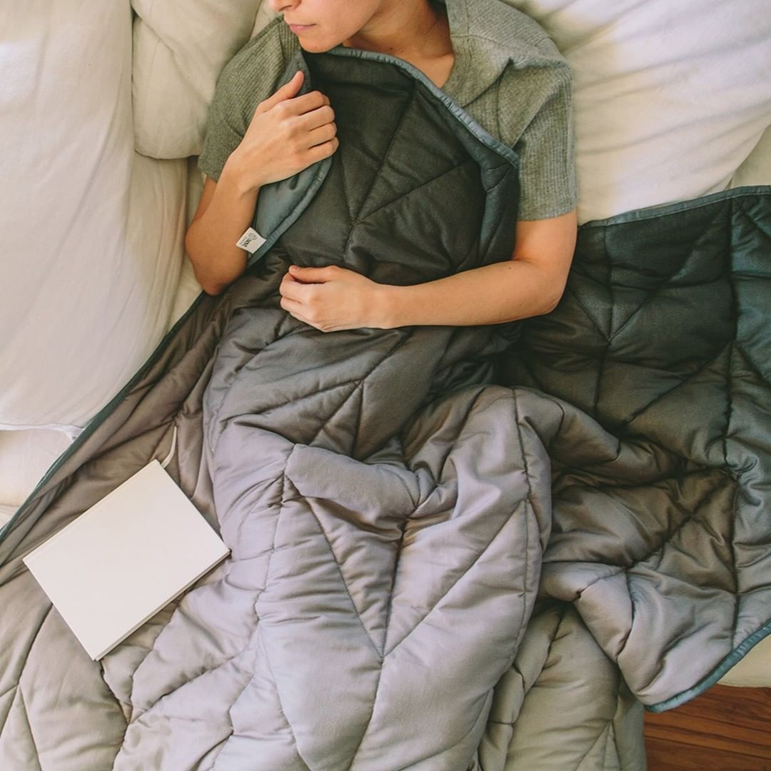 Person holding Nest Bedding weighted blanket