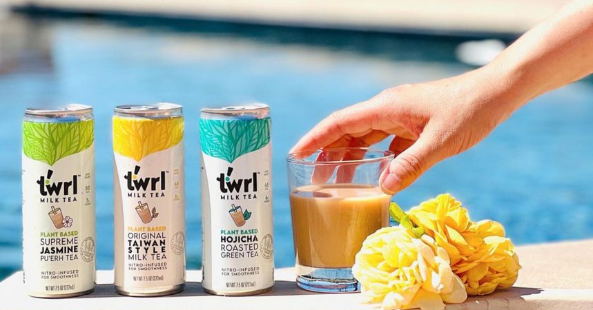 Person grabbing Twrl drink with cans of Twrl near water