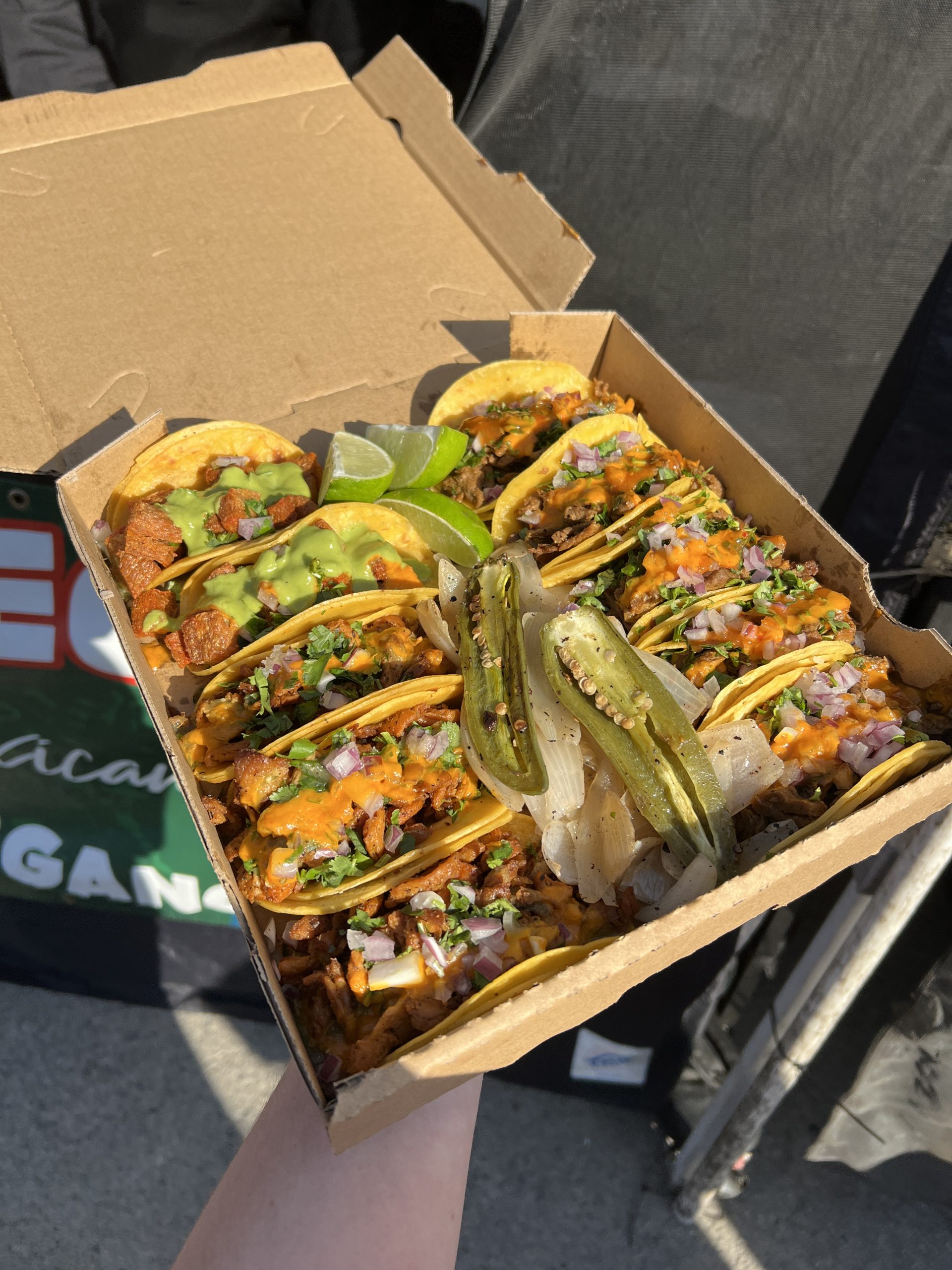 Person holding box of tacos from El Compa Veagno