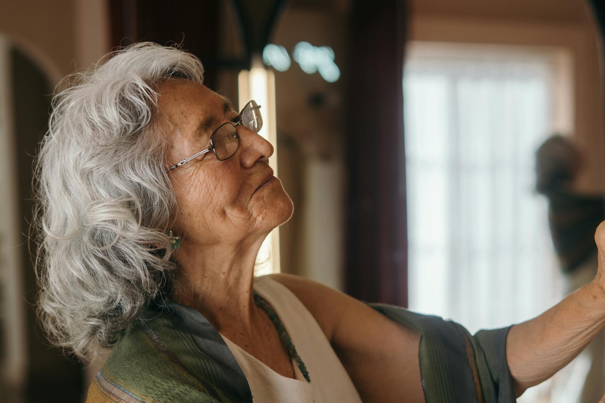 Charming portrait of an elderly woman with a warm expression indoors.