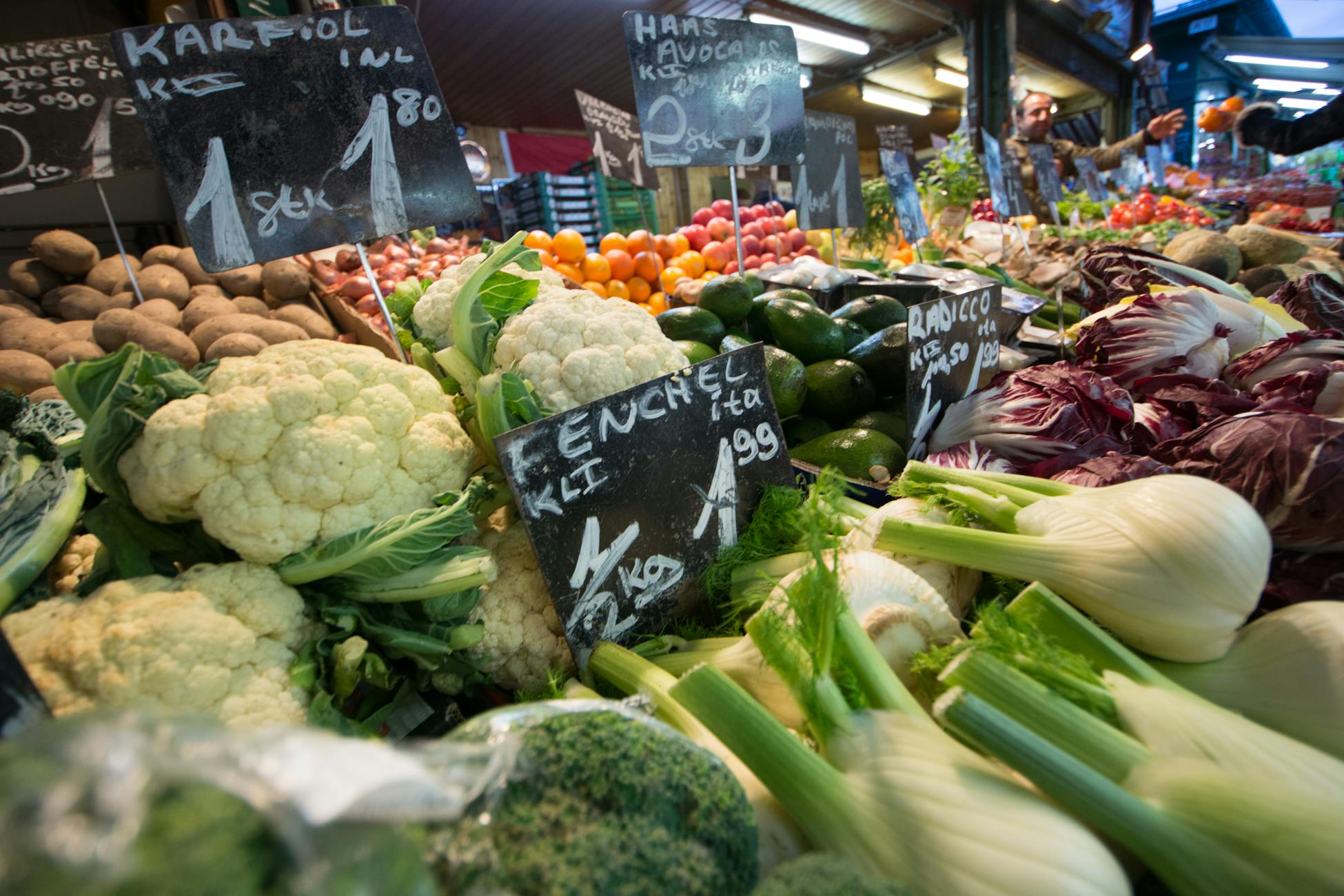 A vibrant display of fresh vegetables at a local market stall, showcasing a variety of produce.