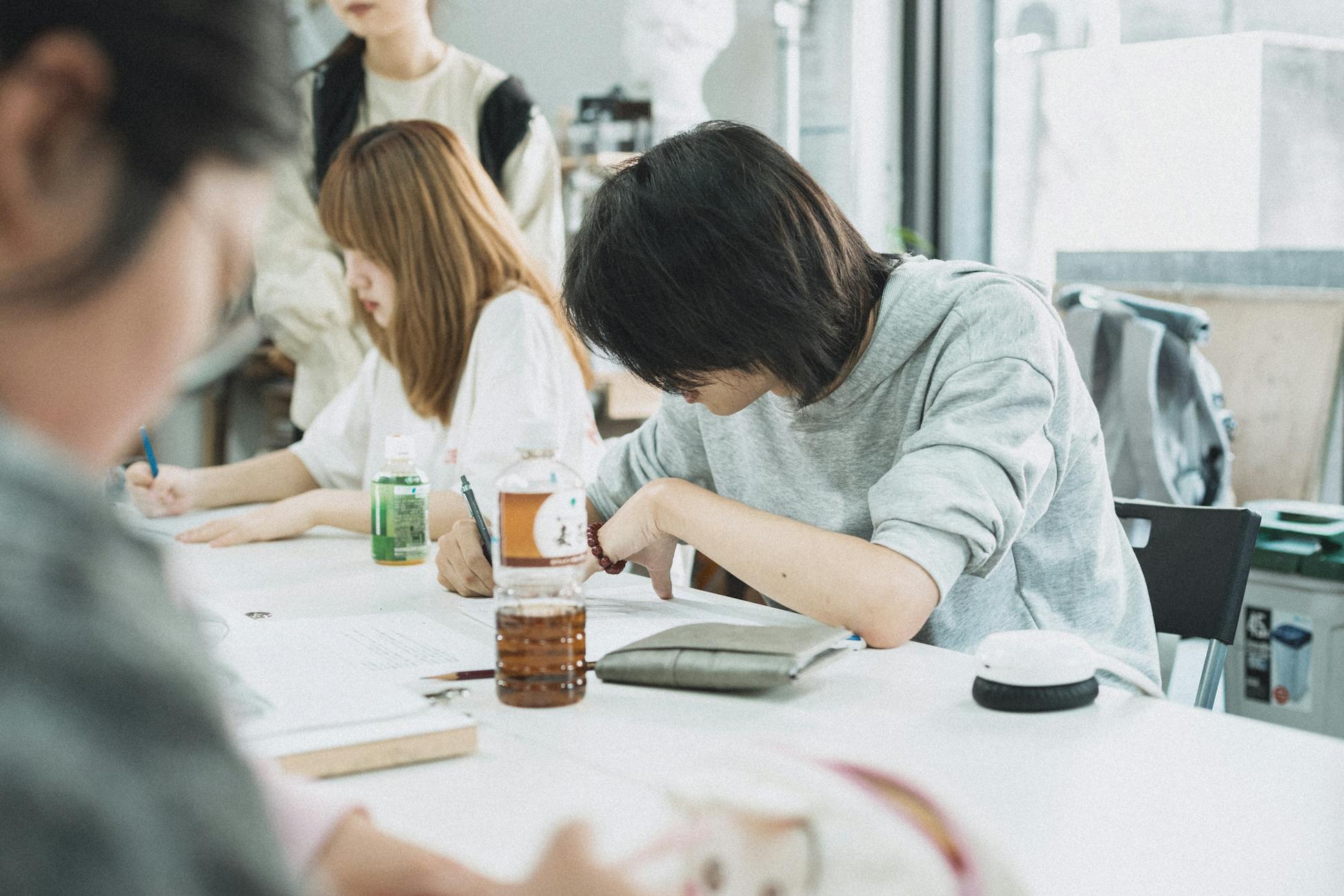 Students engaged in group study in a Tokyo classroom, fostering a collaborative learning atmosphere.