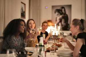 Women laughing together at dinner gathering