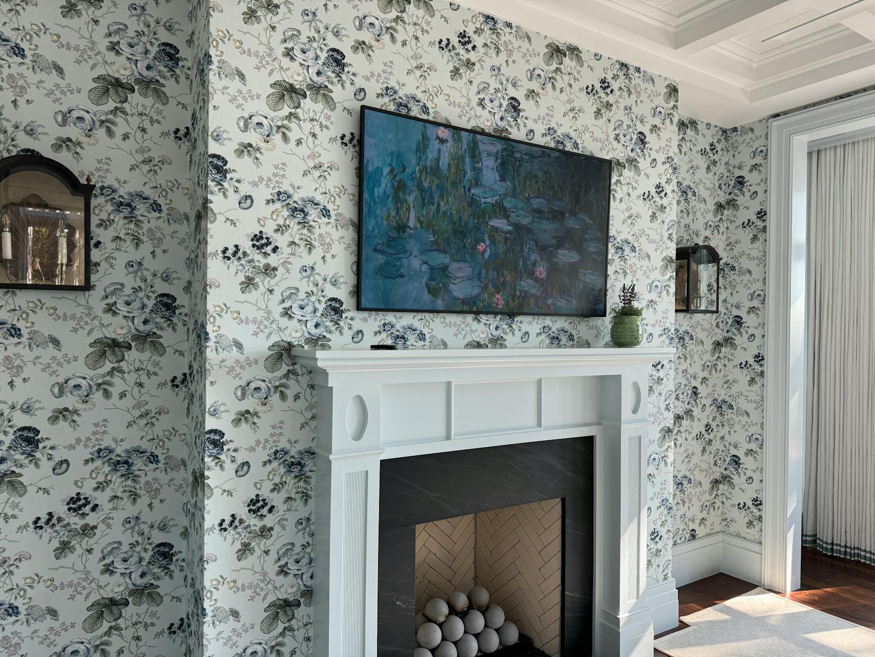 Stylish living room in Bluffton, SC, featuring a floral wallpaper and modern fireplace.