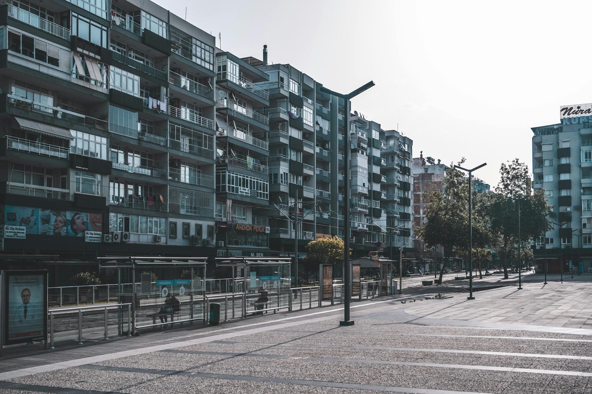 Wide-angle view of urban apartment buildings and street in daylight.