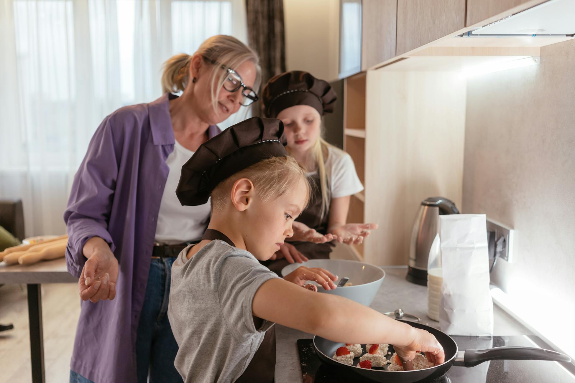 A family cooking together with children and a grandmother in a cozy kitchen.