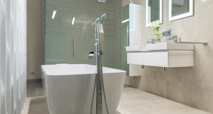 A chic and contemporary bathroom featuring a freestanding tub and elegant fixtures.