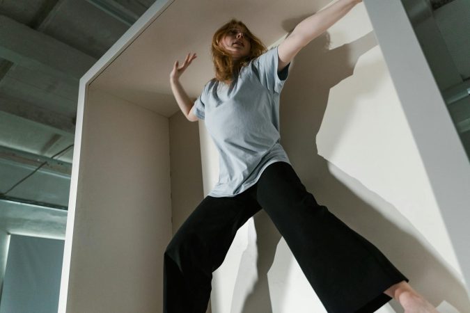 A woman in a confined space depicting anxiety and claustrophobia indoors.