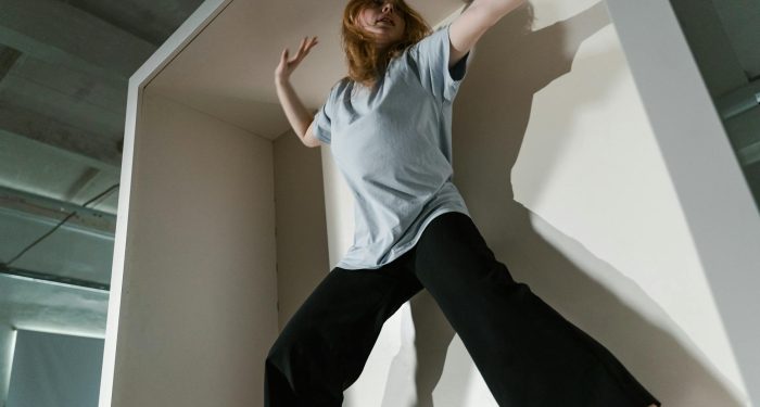 A woman in a confined space depicting anxiety and claustrophobia indoors.