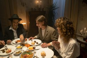 A festive indoor gathering with family sharing a traditional meal by candlelight.