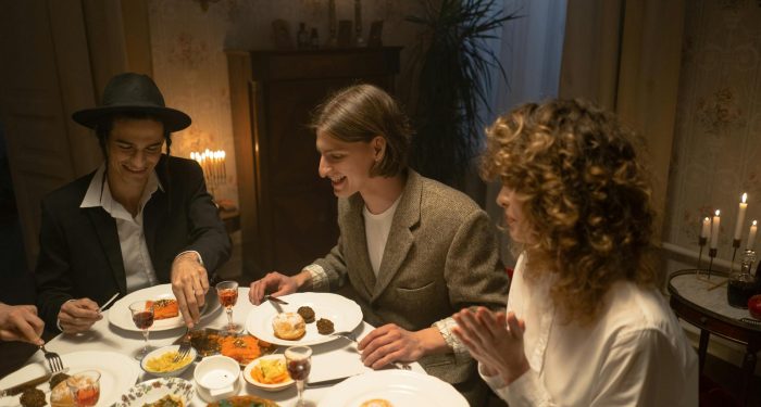 A festive indoor gathering with family sharing a traditional meal by candlelight.